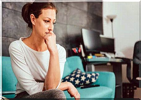 Anxious woman sitting on a sofa. 